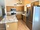 Kitchen features stainless steel appliances, granite counters, an island and ample cabinet storage at 9109 W Watson Ln, Peoria, AZ 85381