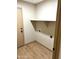 Functional laundry room equipped with convenient hookups and a spacious shelf at 9109 W Watson Ln, Peoria, AZ 85381