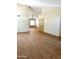 Open living room features light wood flooring, neutral paint, and ceiling fan at 9109 W Watson Ln, Peoria, AZ 85381