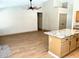 Open-concept living area flows into kitchen with wood-look floors and ceiling fan at 9109 W Watson Ln, Peoria, AZ 85381
