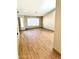 Living room with light wood flooring, neutral paint, and large window at 9109 W Watson Ln, Peoria, AZ 85381