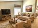 Inviting living room with comfortable seating, rustic wood furniture, and warm, neutral tones at 9109 W Watson Ln, Peoria, AZ 85381