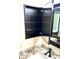 An open, recessed medicine cabinet, with an adjacent sink and granite countertop at 9109 W Watson Ln, Peoria, AZ 85381