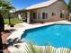 Backyard pool surrounded by vibrant landscaping, creating a serene and inviting outdoor oasis for relaxation at 9109 W Watson Ln, Peoria, AZ 85381
