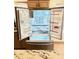 Open stainless steel refrigerator reveals ample space for food storage with adjustable shelves at 9109 W Watson Ln, Peoria, AZ 85381