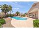 Backyard oasis featuring a private pool, mature landscaping, and a covered patio at 9239 E Karen Dr, Scottsdale, AZ 85260