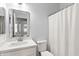 Bathroom featuring a quartz countertop, a shower, and a modern mirror at 9239 E Karen Dr, Scottsdale, AZ 85260