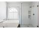 Bathroom featuring a soaking tub and a separate glass-enclosed shower at 9239 E Karen Dr, Scottsdale, AZ 85260