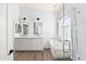 Elegant bathroom featuring double sinks and a luxurious soaking tub at 9239 E Karen Dr, Scottsdale, AZ 85260
