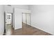 Bedroom with wood-look flooring, mirrored closet doors, and access to bathroom at 9239 E Karen Dr, Scottsdale, AZ 85260