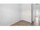 Bedroom with wood-look flooring and a closet with white paneled doors at 9239 E Karen Dr, Scottsdale, AZ 85260