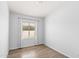 Bright bedroom features a window with wood-look flooring and neutral walls at 9239 E Karen Dr, Scottsdale, AZ 85260