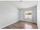 Bright, neutral bedroom with wood-look flooring and a sunny window with curtains at 9239 E Karen Dr, Scottsdale, AZ 85260