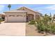 Charming single-story home featuring a well-maintained front yard and attached two-car garage at 9239 E Karen Dr, Scottsdale, AZ 85260