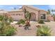 Beautiful home with desert landscaping, a two-car garage and an arched front entry at 9239 E Karen Dr, Scottsdale, AZ 85260