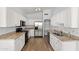 Bright kitchen with white cabinetry, granite countertops, and stainless steel appliances at 9239 E Karen Dr, Scottsdale, AZ 85260