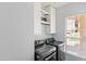 The laundry room has a window, shelving, and modern front-loading machines at 9239 E Karen Dr, Scottsdale, AZ 85260