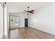 Bright living room with high ceilings, wood-look flooring, and a modern ceiling fan at 9239 E Karen Dr, Scottsdale, AZ 85260