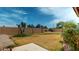 Large backyard with a spacious lawn, tall privacy fence, and minimal landscaping at 9814 W Menadota Dr, Peoria, AZ 85382