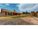 View of backyard with stone patio, lawn area, and a covered porch at 9814 W Menadota Dr, Peoria, AZ 85382