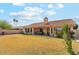 Back exterior view of a house with a large backyard, patio area, and desert landscaping at 9814 W Menadota Dr, Peoria, AZ 85382