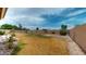 Spacious backyard featuring rock accents, grass and a tall block fence at 9814 W Menadota Dr, Peoria, AZ 85382