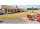 Backyard featuring a large lawn area, a covered patio and low-maintenance landscaping at 9814 W Menadota Dr, Peoria, AZ 85382