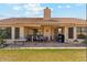 Spacious backyard with a covered patio area, well-maintained lawn and mature landscaping at 9814 W Menadota Dr, Peoria, AZ 85382