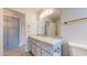 Bathroom featuring granite countertop, vanity with cabinets, and contemporary fixtures at 9814 W Menadota Dr, Peoria, AZ 85382