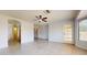 Bedroom with ceiling fan, closet, and access to outdoor patio space at 9814 W Menadota Dr, Peoria, AZ 85382