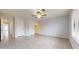 Bright bedroom with tile flooring, closet space, and a window offering natural light at 9814 W Menadota Dr, Peoria, AZ 85382