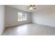 Spacious bedroom featuring neutral walls, tiled floor, a window with blinds, and a ceiling fan at 9814 W Menadota Dr, Peoria, AZ 85382