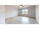Light-filled bedroom with tile flooring, a ceiling fan, and a large window providing ample natural light at 9814 W Menadota Dr, Peoria, AZ 85382