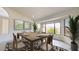 Bright dining room with rustic table, seating for six, and large bay window at 9814 W Menadota Dr, Peoria, AZ 85382