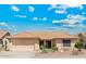 Inviting single-story home with a two-car garage and desert-style landscaping for easy upkeep at 9814 W Menadota Dr, Peoria, AZ 85382