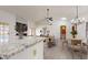 Modern kitchen with sleek granite countertops and a cozy living area, perfect for entertaining at 9814 W Menadota Dr, Peoria, AZ 85382