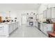Well-equipped kitchen with stainless steel appliances, ample counter space, and bright, white cabinets at 9814 W Menadota Dr, Peoria, AZ 85382