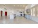 Updated kitchen features stainless steel appliances and light wood cabinets, with a center island at 9814 W Menadota Dr, Peoria, AZ 85382