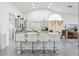Modern kitchen featuring an island with seating, sleek countertops, and stainless steel appliances at 9814 W Menadota Dr, Peoria, AZ 85382