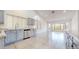 Bright kitchen featuring matching cabinets, granite countertops, stainless steel appliances, and tile flooring at 9814 W Menadota Dr, Peoria, AZ 85382