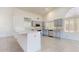 Updated kitchen features stone countertops, stainless steel appliances, and light wood cabinetry at 9814 W Menadota Dr, Peoria, AZ 85382