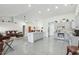 Spacious open-concept living area connecting the kitchen, dining, and living room for entertaining at 9814 W Menadota Dr, Peoria, AZ 85382