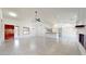 Open-concept living area with the kitchen, a red door and a fireplace at 9814 W Menadota Dr, Peoria, AZ 85382