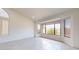 Bright, spacious living room with large windows and tile flooring at 9814 W Menadota Dr, Peoria, AZ 85382