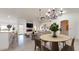 Open-concept living space with modern finishes, a fireplace, and a view into the dining and kitchen areas at 9814 W Menadota Dr, Peoria, AZ 85382