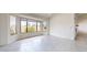 Bright and airy living room with a large bay window, neutral walls, and tile flooring at 9814 W Menadota Dr, Peoria, AZ 85382