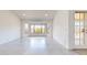 Well-lit living room with large bay window, neutral palette, and tile flooring at 9814 W Menadota Dr, Peoria, AZ 85382