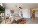 Bright main bedroom featuring stylish decor, large window, and ceiling fan at 9814 W Menadota Dr, Peoria, AZ 85382