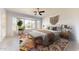 Light-filled bedroom with large windows, ceiling fan, and neutral decor at 9814 W Menadota Dr, Peoria, AZ 85382