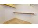 This walk-in closet features a carpeted floor, white walls, and shelving units for optimal storage at 9814 W Menadota Dr, Peoria, AZ 85382